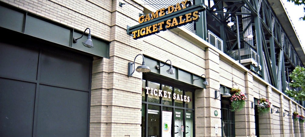 white-brick-building-ticket-office-sign